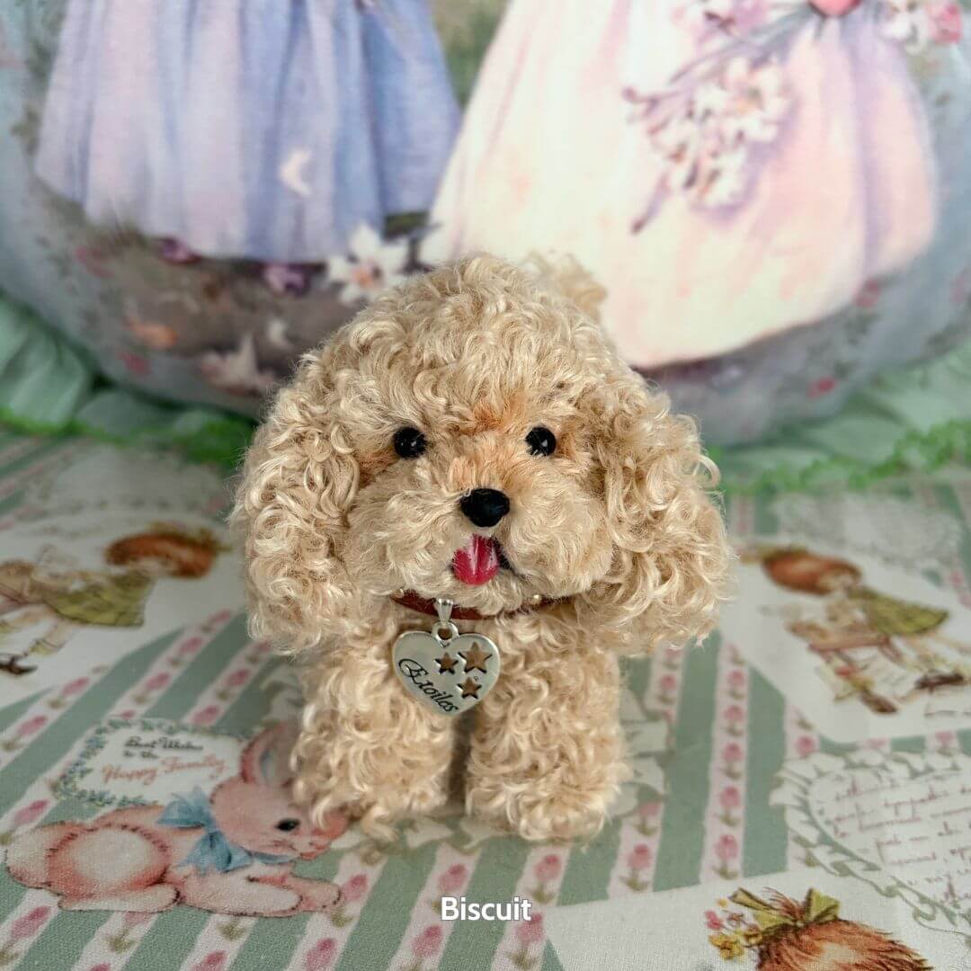 Lifelike Puppy Collection of a fluffy beige puppy with curly fur and a heart-shaped collar, posing cutely on a patterned background.