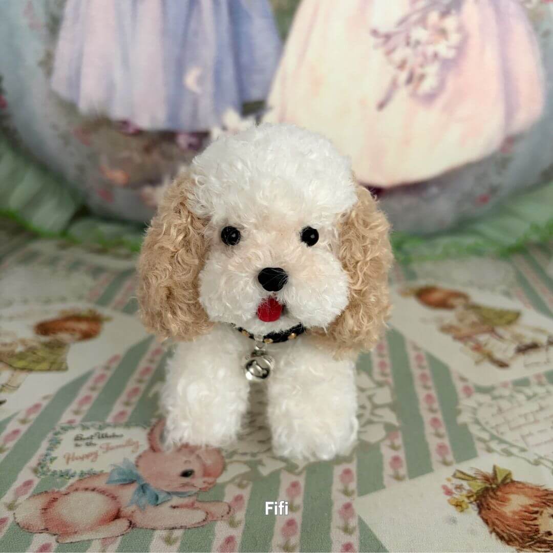 Lifelike Puppy Collection, fluffy white and tan puppy figurine with a collar, cutely posed on a floral background.
