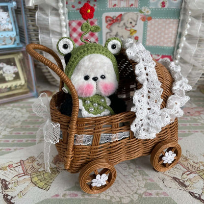 Handmade mini panda with movable joints in crochet hat and apron, sitting in a decorative basket, perfect as a unique gift.
