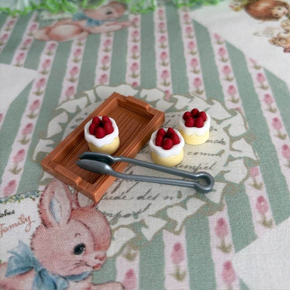 Mini Strawberry Cake Set with three tiny cakes topped with strawberries on a wooden tray, featuring a miniature serving fork.