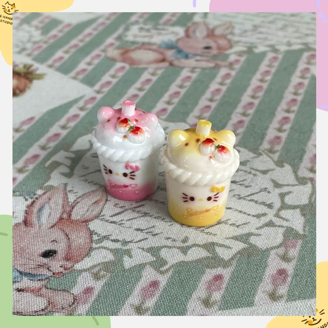 Mini cat-themed milkshake decorations for dollhouse decor, featuring pink and yellow designs, ideal for cat lovers and collectors.