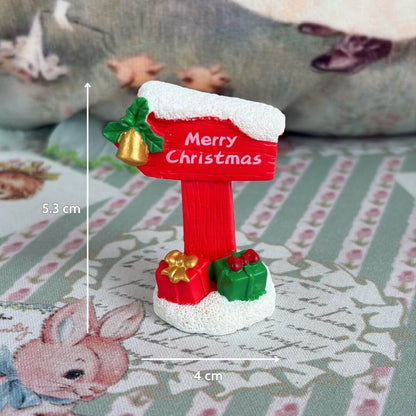 Miniature Christmas Accessories featuring a handmade kitten present sign with festive decorations, perfect for dollhouses and dioramas.