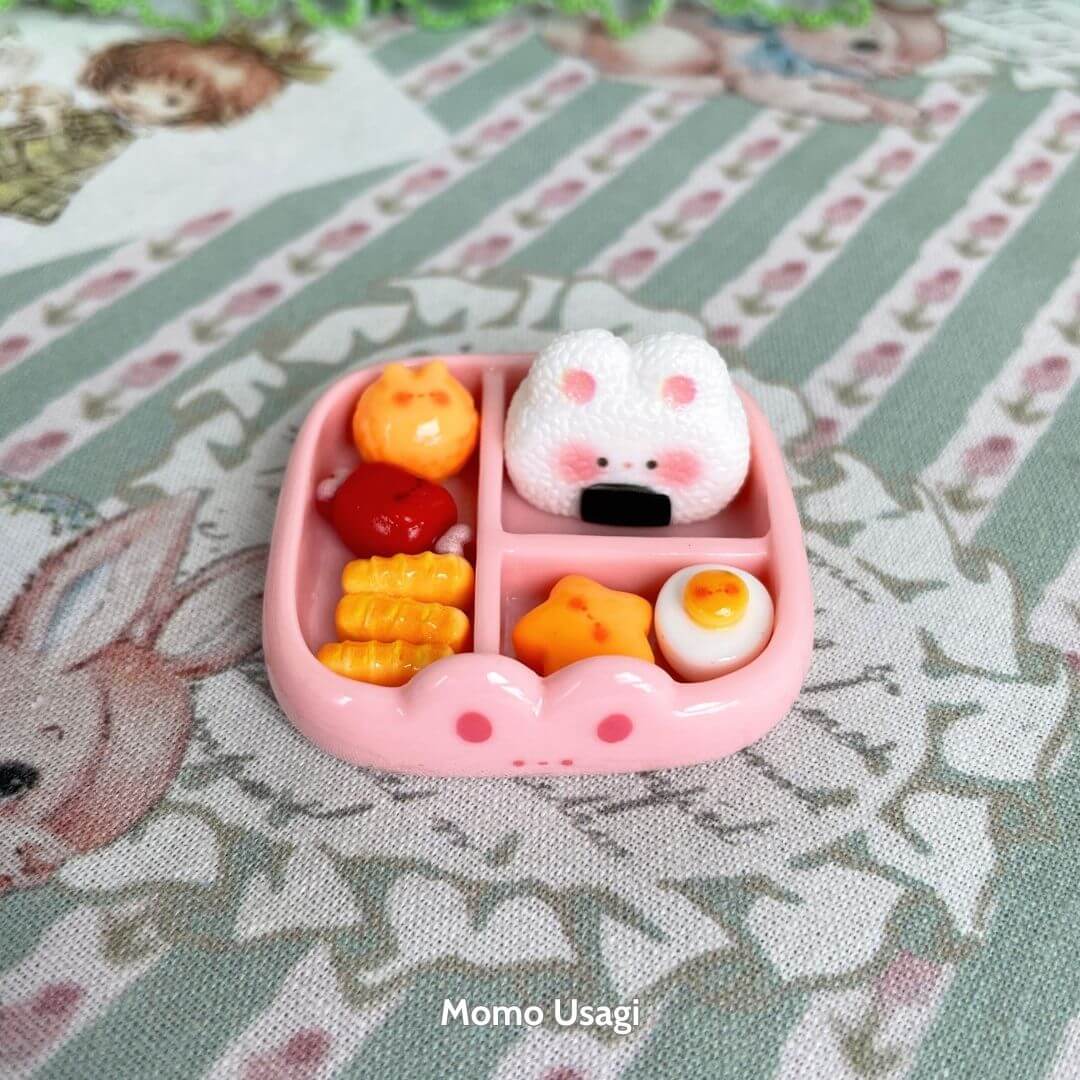 Mini Cat Bento Box featuring a cute fluffy kitten-shaped onigiri and miniature food items in a pink tray, handmade collectible decor.