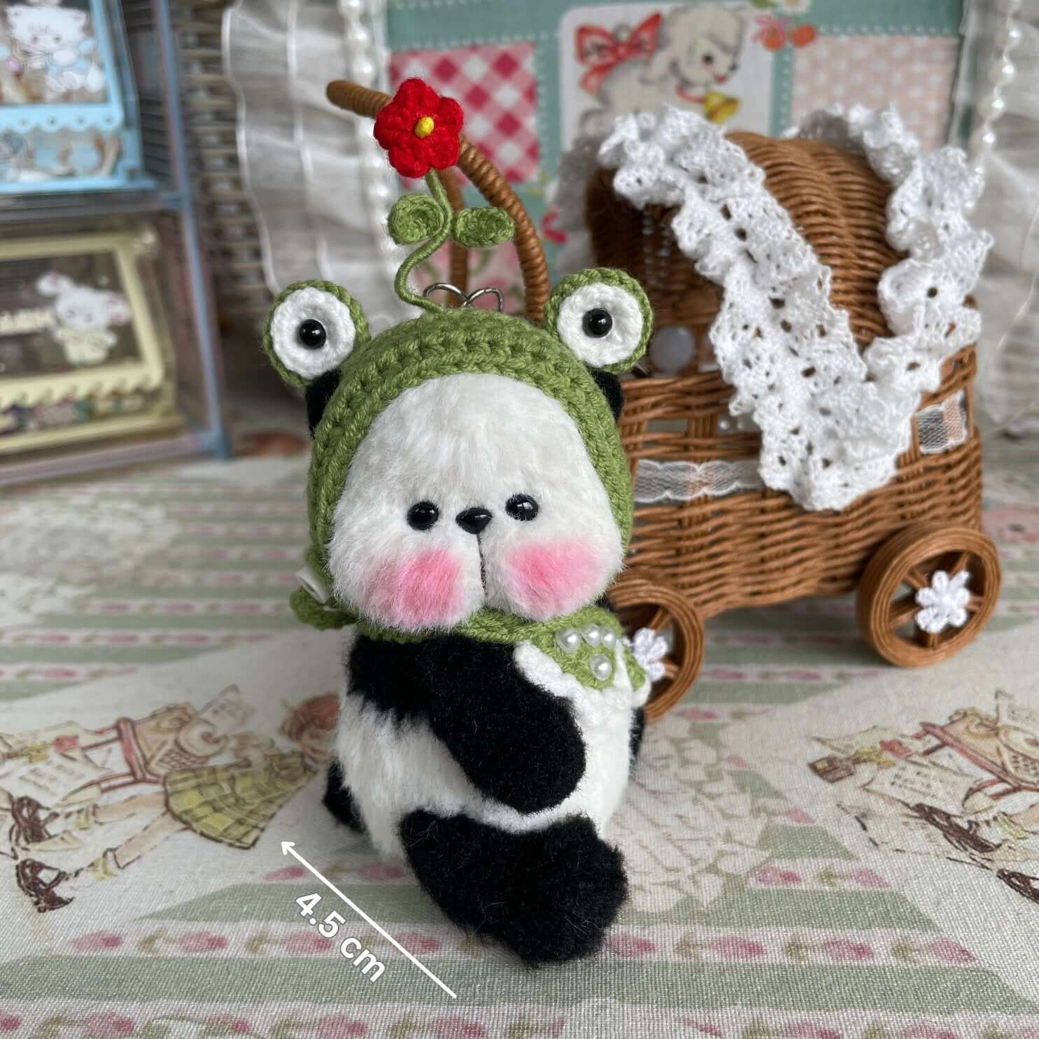 Handcrafted mini panda with movable joints, wearing crochet hat and apron; perfect as a small animal decoration or unique gift.