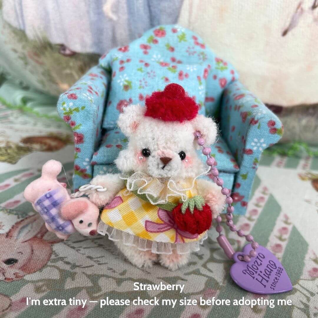 Adorable handmade miniature Pipe Cleaner Animals, featuring a fluffy kitten with a red hat, holding a bunny plush toy.