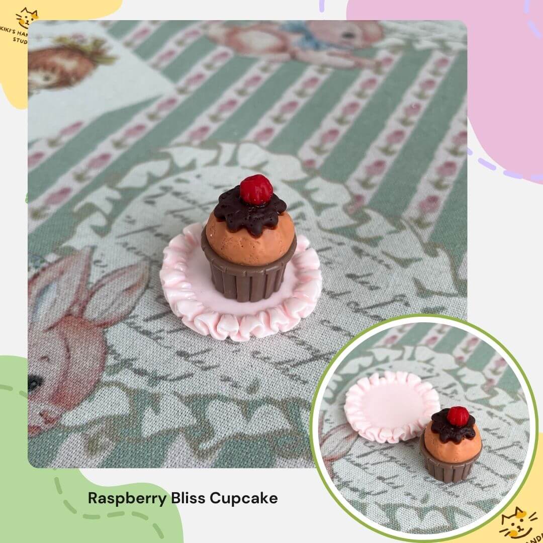 Miniature cat-themed cupcake decoration on floral fabric, perfect for dollhouse or desk displays. Whimsical charm for collectors.