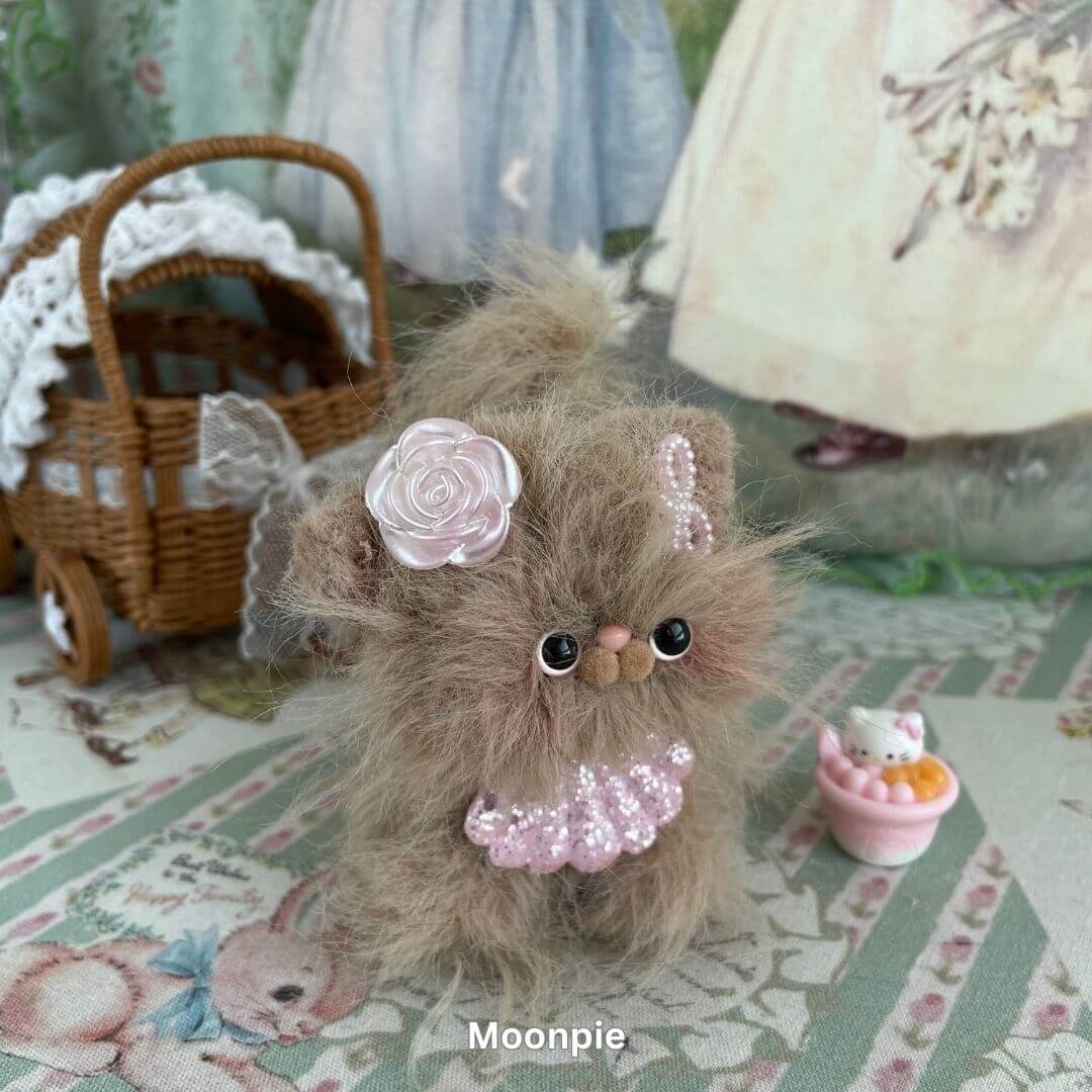 Handmade fluffy kitten plush toy from the Siberian Snuggles Collection, featuring soft faux fur and pink accessories.