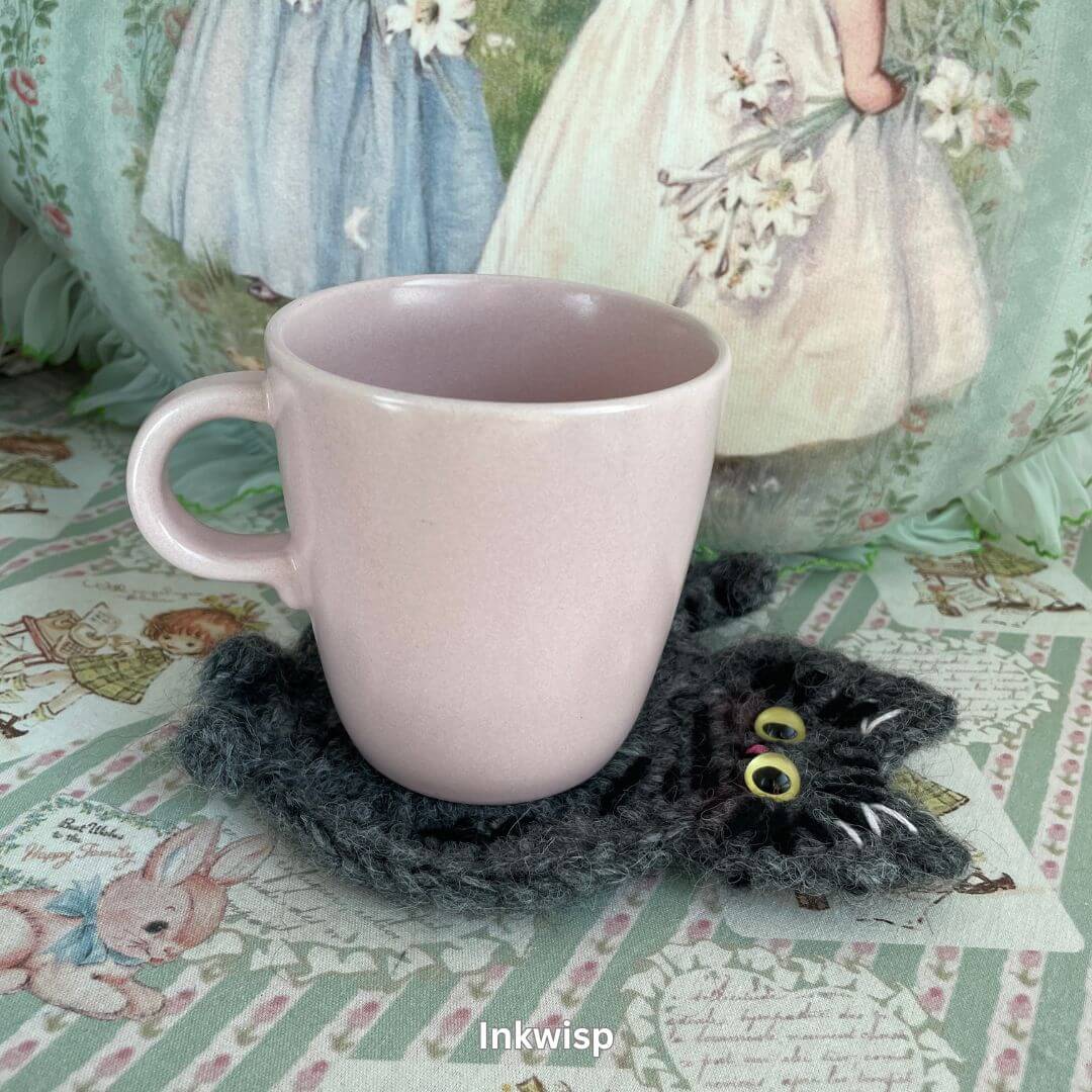 Pastel pink mug on a SnugglePaws handmade cat-themed coaster, featuring a charming hand-crafted kitten, ideal for adding decor to spaces.