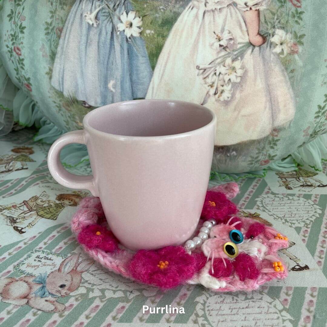 Cute handmade coaster with pink plush kitten design, perfect for coffee mugs, adding charm to your decor. Cat-themed and decorative.