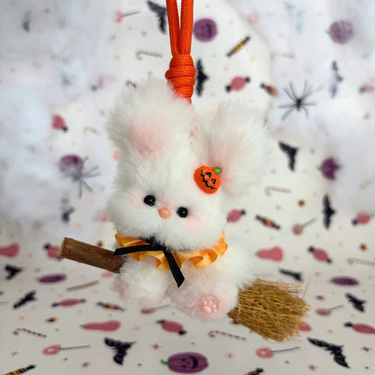 White long-eared friend on a broom with a pumpkin charm and orange ruff.