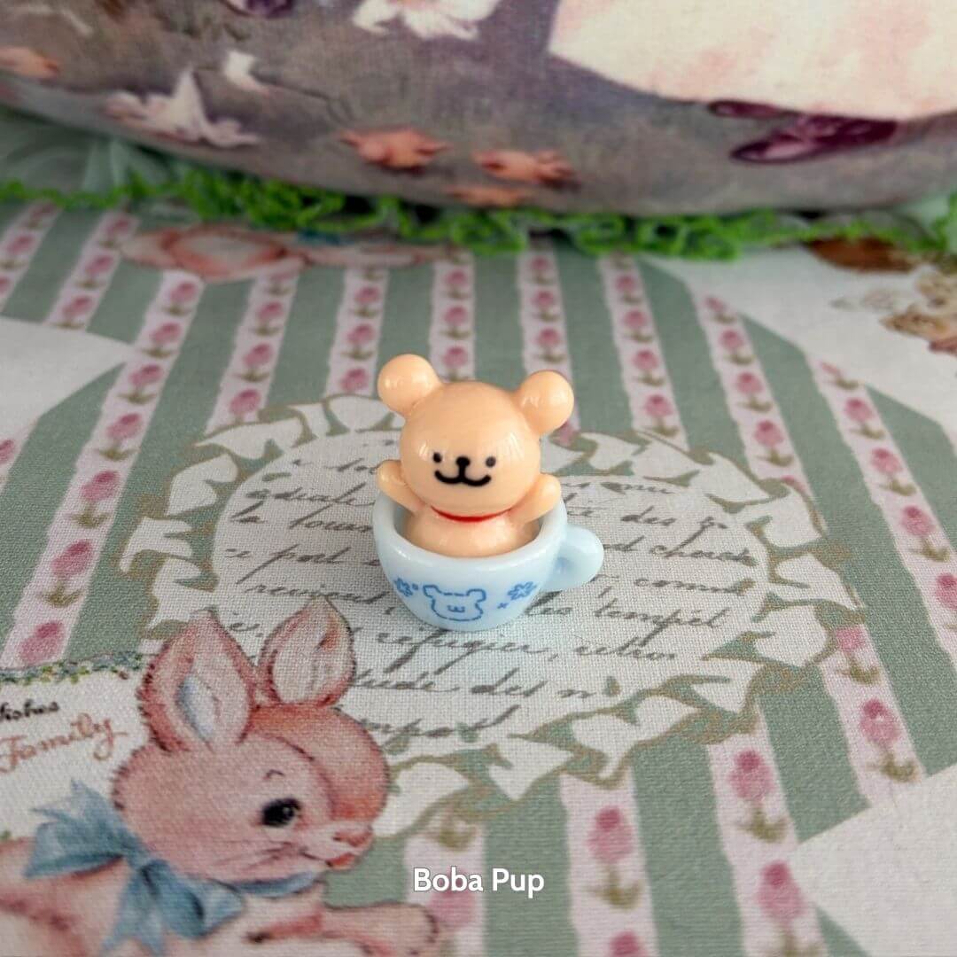 Tiny Puppy Cup featuring a cute bear peeking from a blue cup, soft colors, perfect for animal lovers and decorative accents.