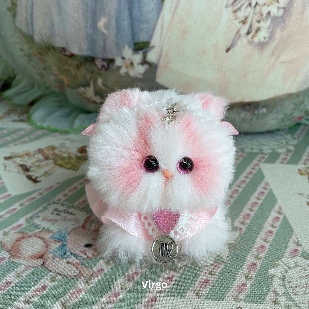 Handmade Virgo zodiac kitten plush toy with pink faux fur, adorned with heart charm and delicate accessories.