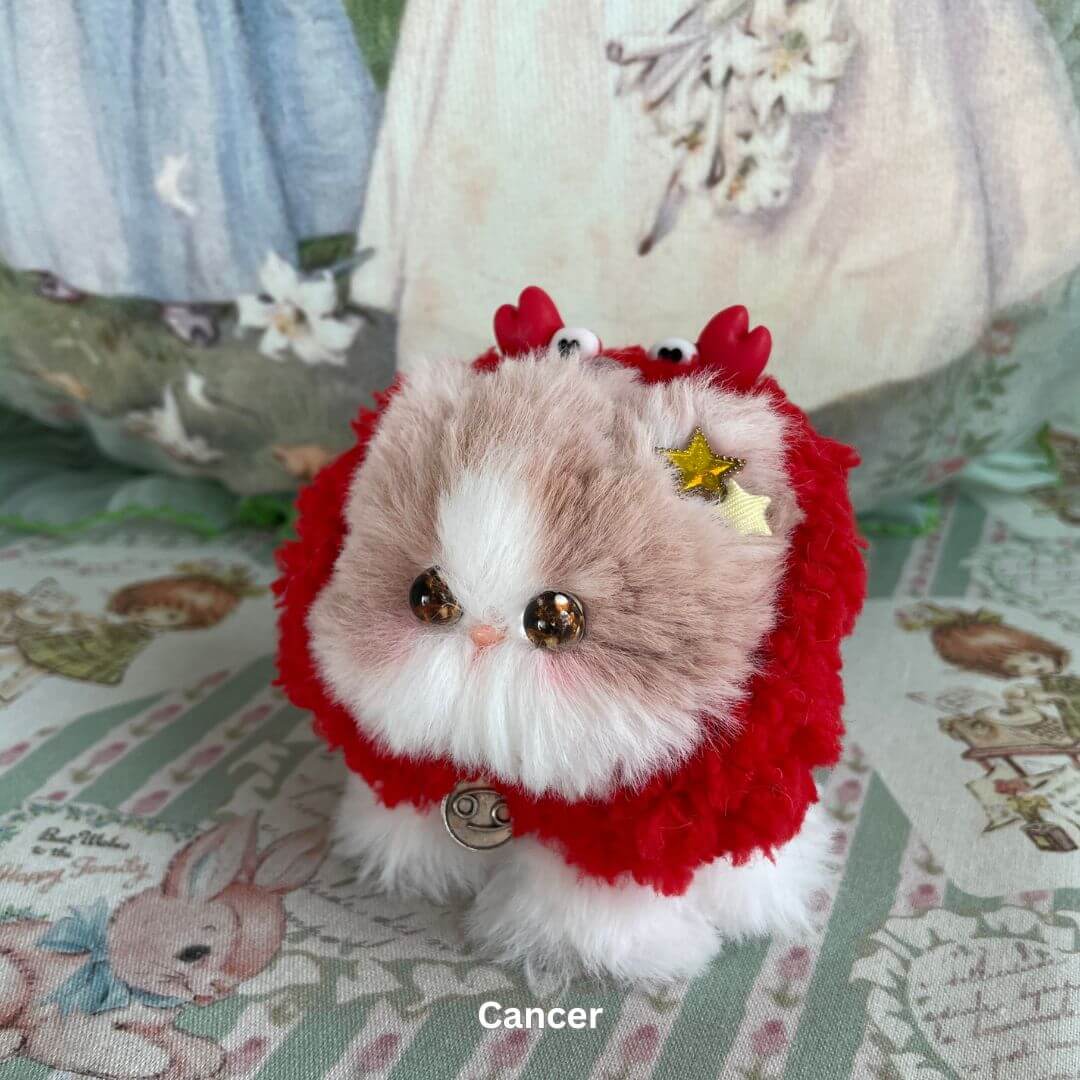 Handmade Cancer zodiac kitten plush with red faux fur, star charm, and crab-like horns, part of the Zodiac Kitten Collection.