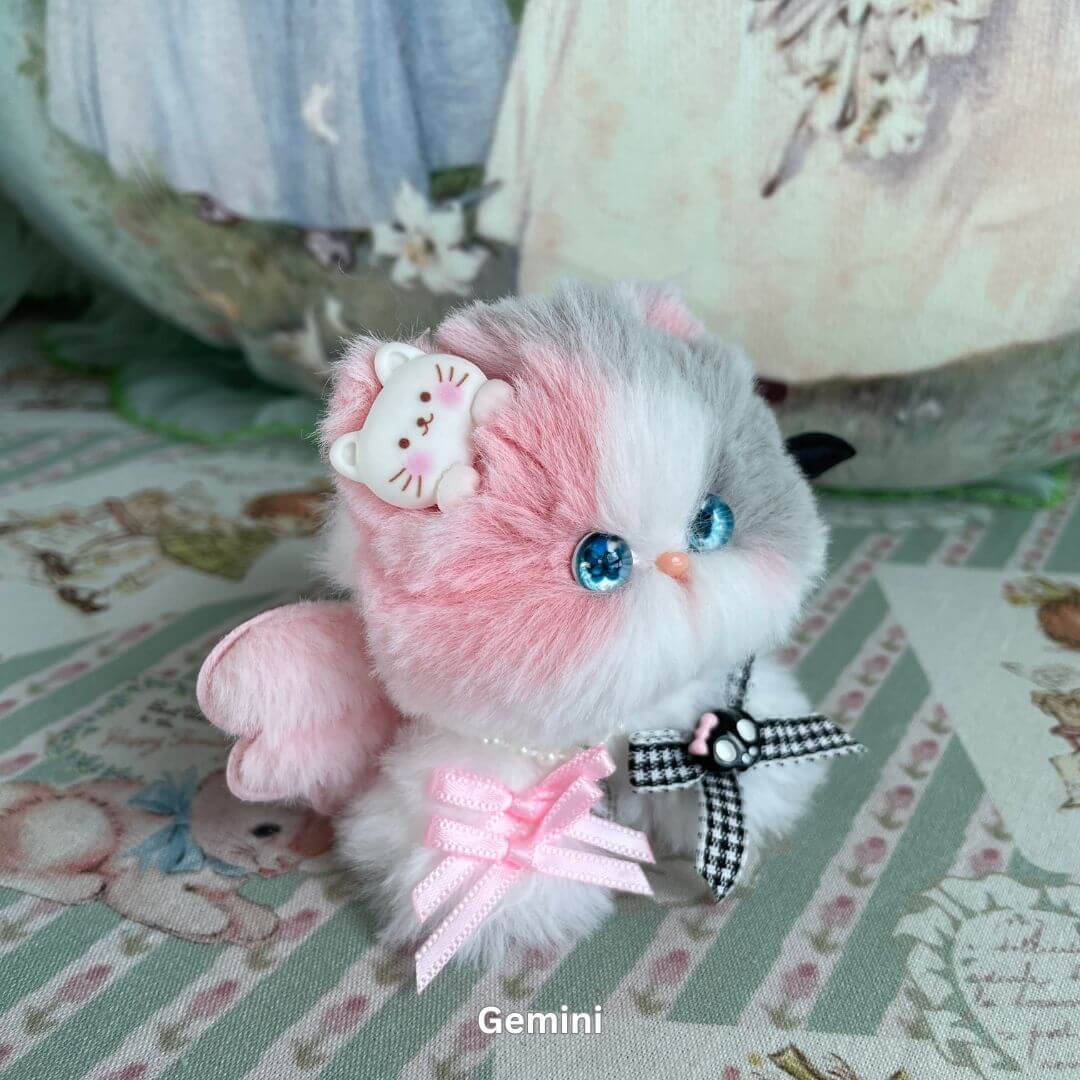 Gemini kitten plush with pink and gray faux fur, adorned with bows and a tiny cat charm from the Zodiac Kitten Collection.