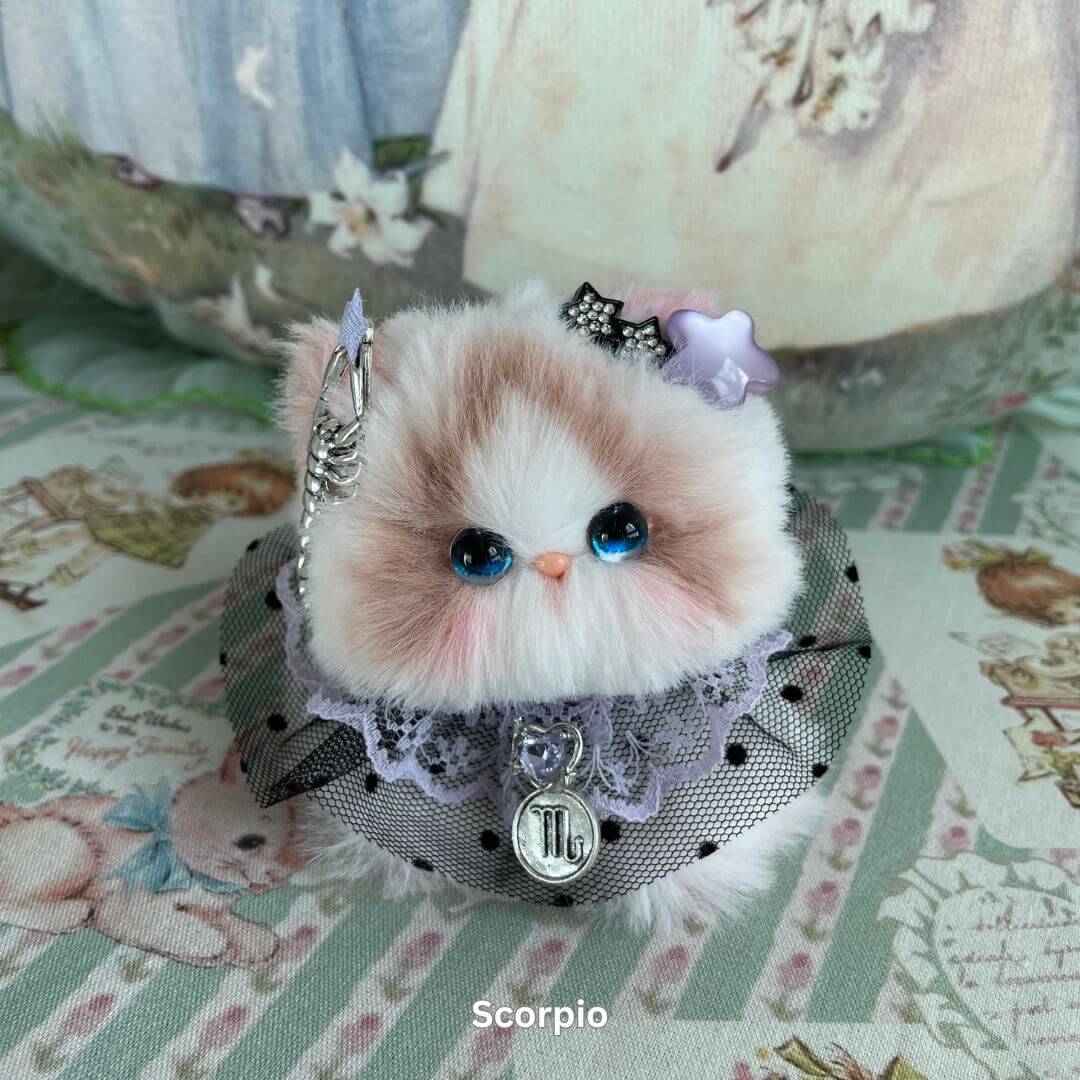 Handmade Scorpio kitten plush with faux fur, adorned with lace collar, charms, and accessories, part of Zodiac Kitten Collection.